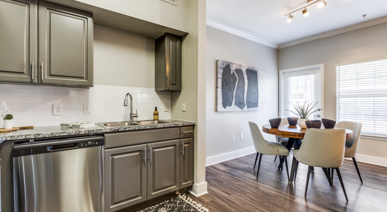 kitchen with stainless steel appliances and gray cabinets at The Ellwood at Lake Travis