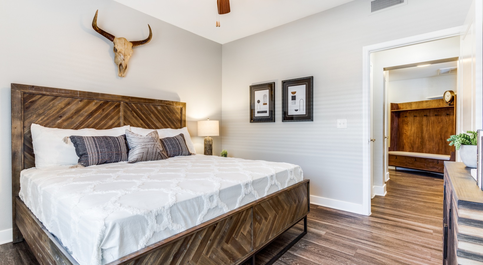 a bedroom with a wooden bed and a headboard at The Ellwood at Lake Travis
