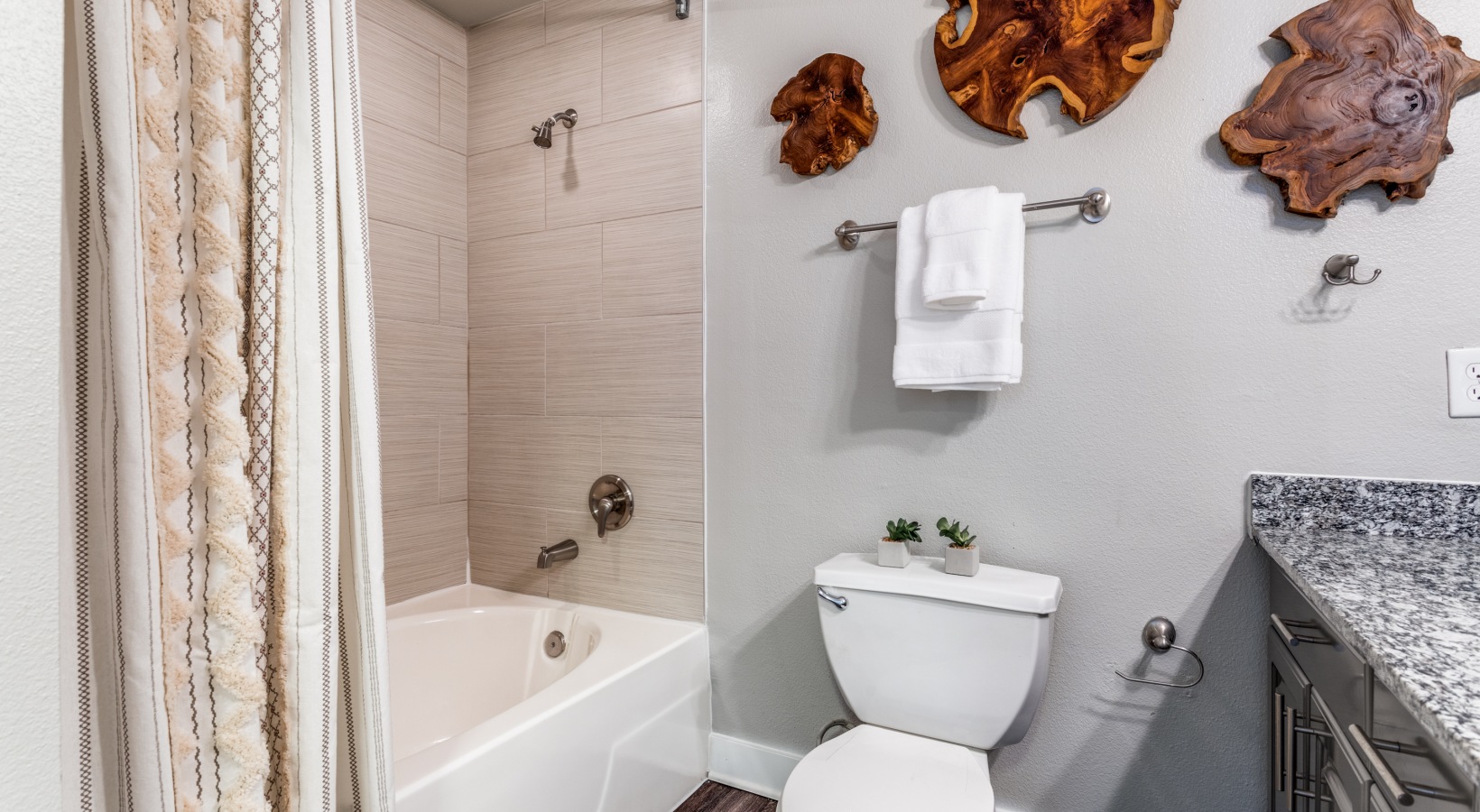 a bathroom with a toilet, sink and shower at The Ellwood at Lake Travis