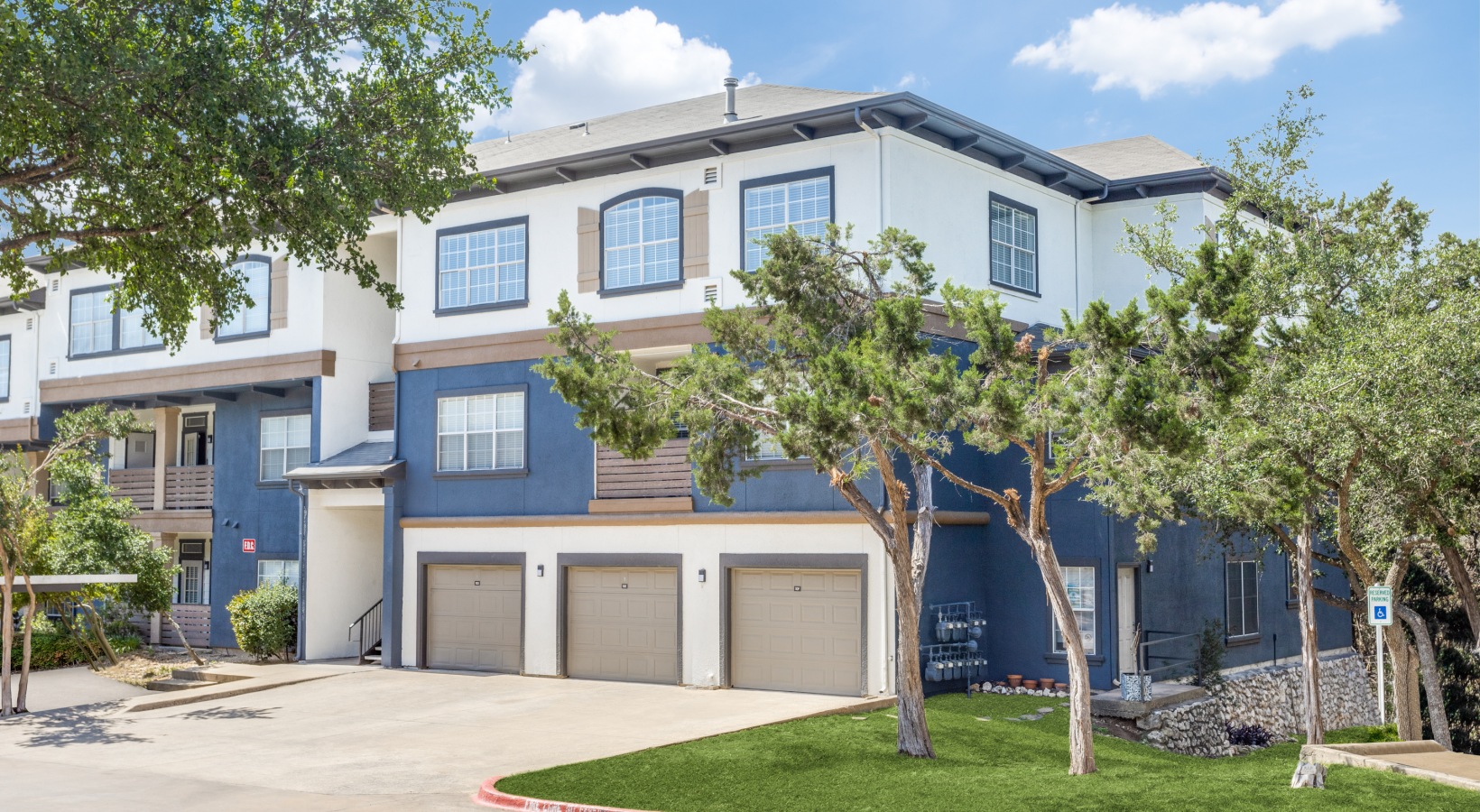 the exterior of a two story apartment building at The Ellwood at Lake Travis