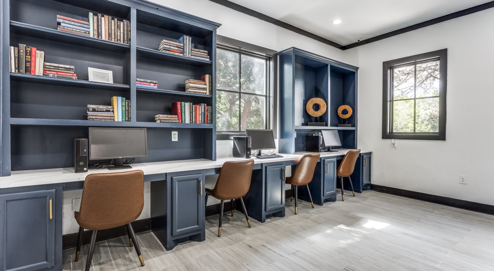 a home office with blue cabinets and a desk at The Ellwood at Lake Travis