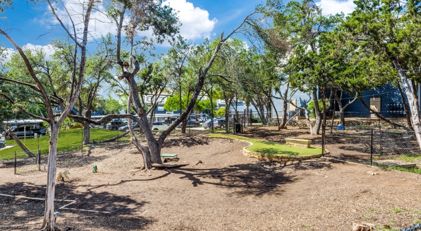 a park with trees and a playground at The Ellwood at Lake Travis