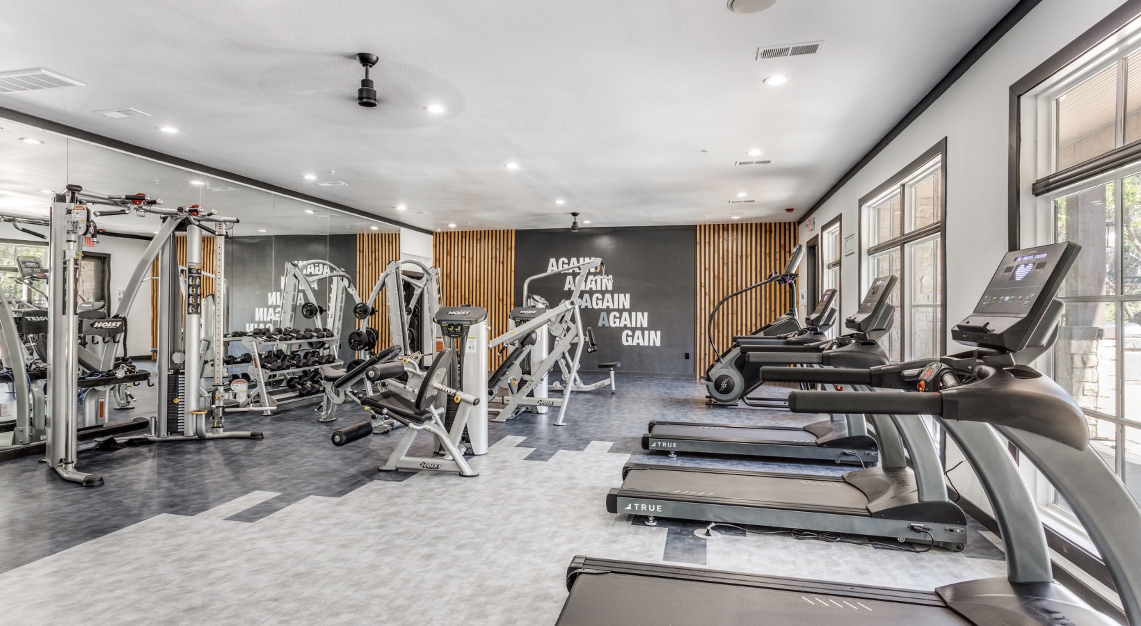a gym room with tread machines and treads at The Ellwood at Lake Travis