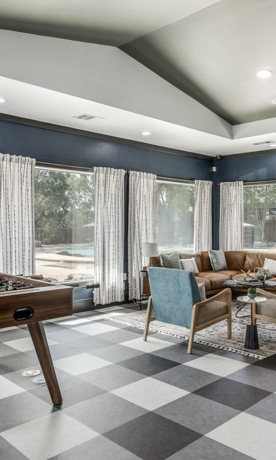 a game room with checkered flooring and a pool table at The Ellwood at Lake Travis