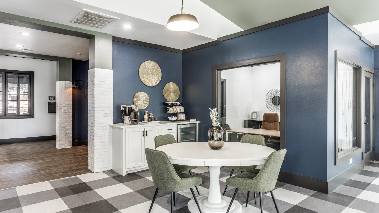 a dining room with blue walls and checkered flooring at The Ellwood at Lake Travis