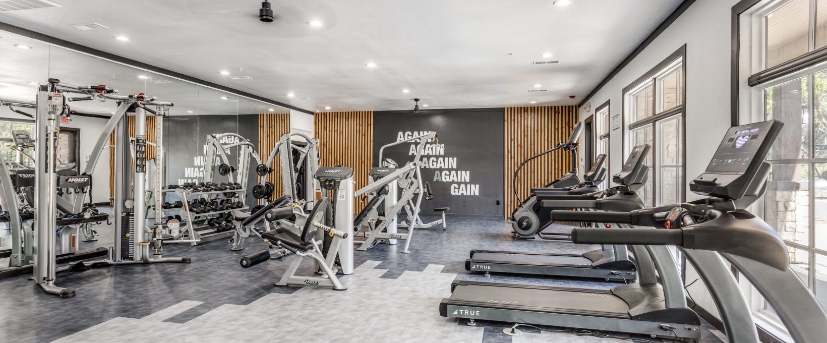 a gym room with tread machines and treads at The Ellwood at Lake Travis